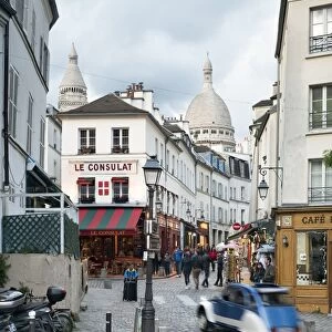 Streets of Montmartre with view towards Basilica Sacre Coeur, Paris, France