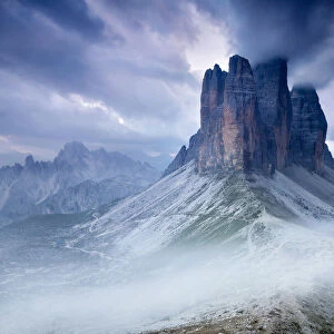 Sunset with clouds on Tre Cime di Lavaredo as seen from Lavaredo fork, Sexten Dolomites