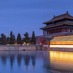 Towers and moat of Forbidden City at dusk, Beijing, China