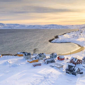 Veines village covered with snow lit by sunrise, Kongsfjord, Varanger Peninsula