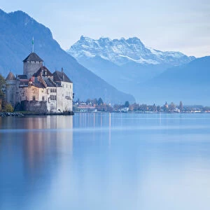 View of the Chillon castle on Lake Geneva and Dents du Midi at sunset. Veytaux, Montreux