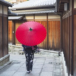 Woman in kimono walking along alleyway, Kyoto, Kansai, Japan (MR)