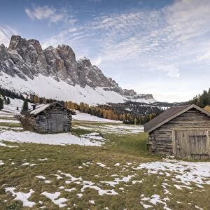 Two wooden lodges and Odle Dolomites. Malga Gampen, Funes, Bolzano, Trentino Alto Adige - Sudtirol