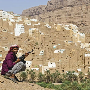 Yemen, Hadhramaut, Wadi Do an, Ribat Ba-Ashan. A happy Yemeni man holds his AK-47