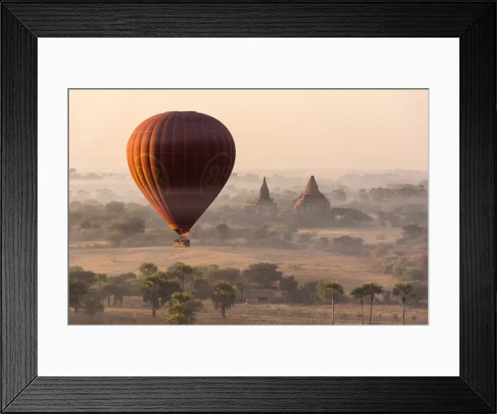 Framed Print : A hot-air balloon flying over pagodas in Bagan, Myanmar Framed Print : A hot-air balloon flying over pagodas in Bagan, Myanmar