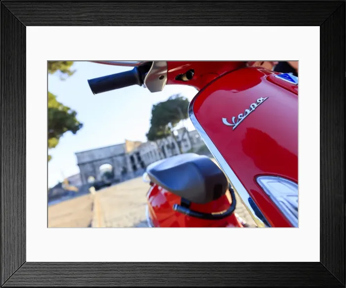 Framed Print : Italy, Rome, a young couple on a red Vespa motorbike enjoying the sunset at Colosseum