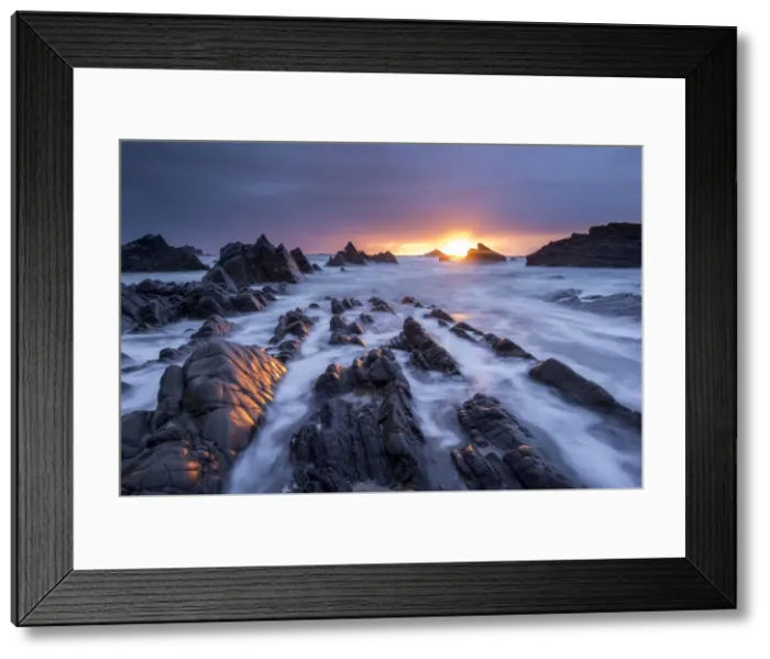 Framed Print : Dramatic sunset over the rocky ledges of Hartland Quay, Devon, England Framed Print : Dramatic sunset over the rocky ledges of Hartland Quay, Devon, England