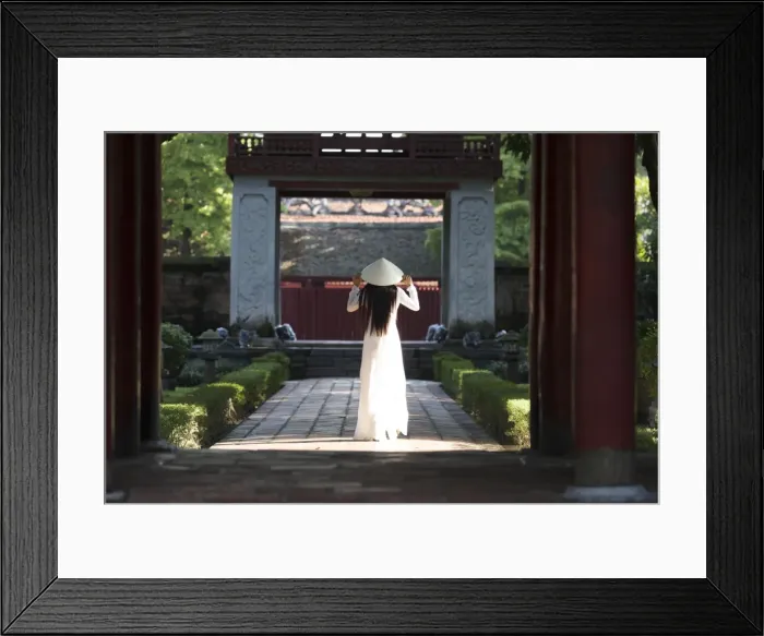 Framed Print : Girl wearing Ao Dai dress and Non La conical hat, Temple of Literature, Hanoi, Vietnam Framed Print : Girl wearing Ao Dai dress and Non La conical hat, Temple of Literature, Hanoi, Vietnam
