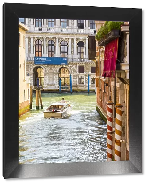 Venice, Veneto, Italy. Buildings and boats in the canals. Ca Pesaro Palace