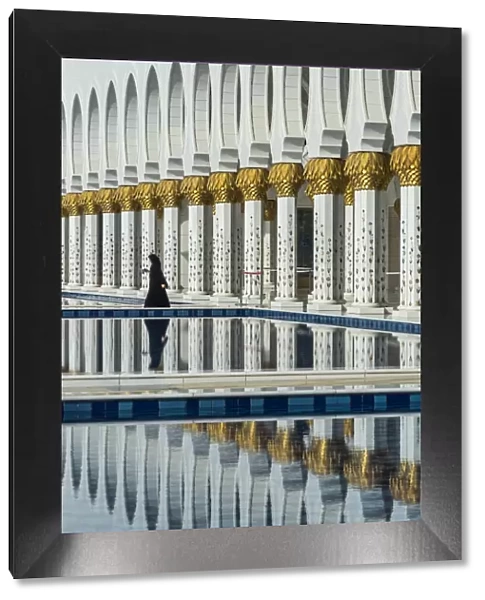 Traditionally Middle Eastern dressed woman walking in the Sheikh Zayed Mosque, Abu Dhabi