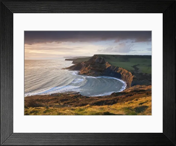 Framed Print : Storm light illuminates Chapmans Pool and Houns Tout cliff, viewed from St Aldhelms Head Framed Print : Storm light illuminates Chapmans Pool and Houns Tout cliff, viewed from St Aldhelms Head