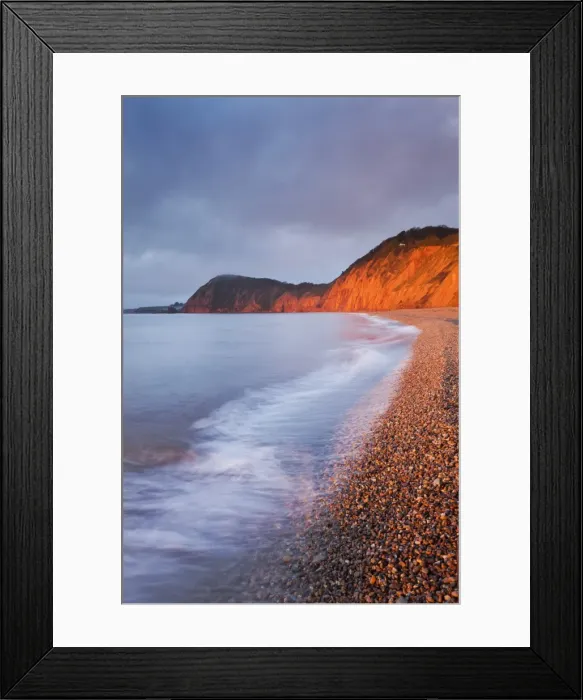 Framed Print : Burning red cliffs at Sidmouth on the Jurassic Coast, Devon, England. Winter Framed Print : Burning red cliffs at Sidmouth on the Jurassic Coast, Devon, England. Winter