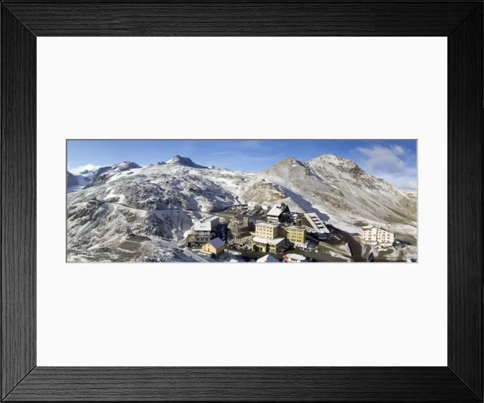 Framed Print : Panoramic view from the Stelvio pass, with a little of snow, and houses and hotels on the Pass Framed Print : Panoramic view from the Stelvio pass, with a little of snow, and houses and hotels on the Pass