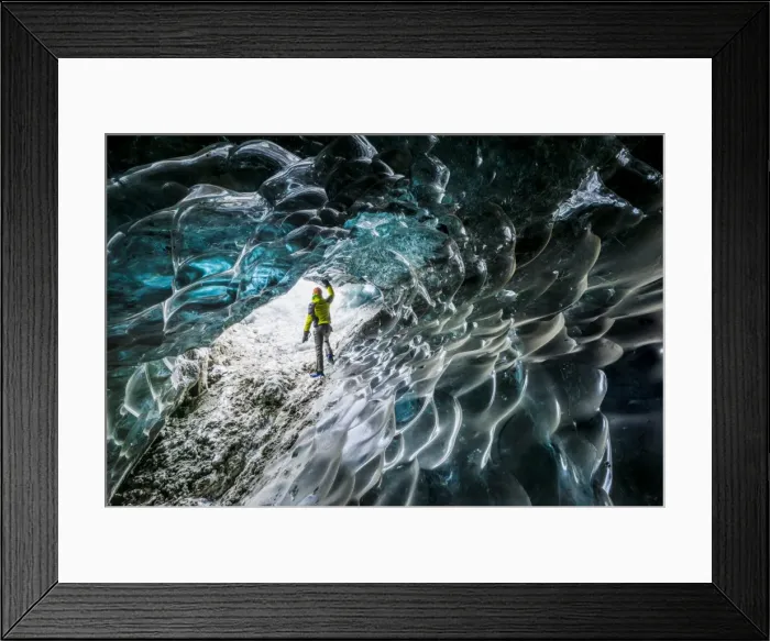 Framed Print : Man inside an ice caver under the Vatnajokull glacier, Vatnajokull national park Framed Print : Man inside an ice caver under the Vatnajokull glacier, Vatnajokull national park