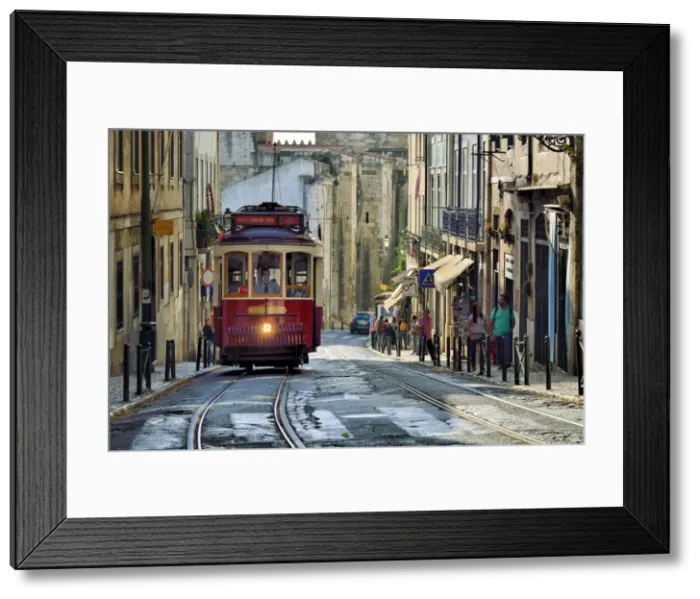 Framed Print : A tramway in Alfama district with the Motherchurch (Se Catedral) in the background Framed Print : A tramway in Alfama district with the Motherchurch (Se Catedral) in the background
