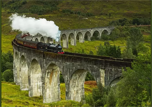 UK, Scotland, Highlands, Jacobite Steam Train crossing the Glenfinnan Viaduct