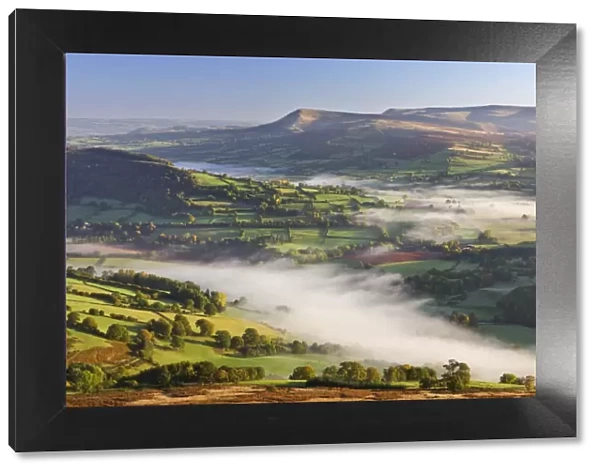 Mist covered rolling countryside backed by the Black Mountains, Brecon Beacons National Park