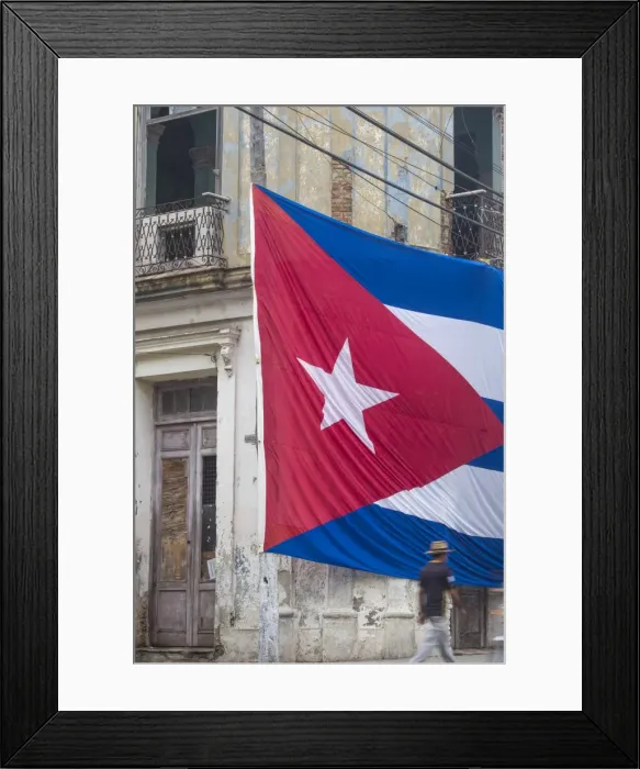 Framed Print : Cuba, Huge Cuban flag hanging across buildings in a street in Santa Clara, after