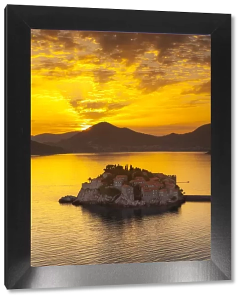 The picturesque island village of Sveti Stephan illuminated at sunset, Sveti Stephan