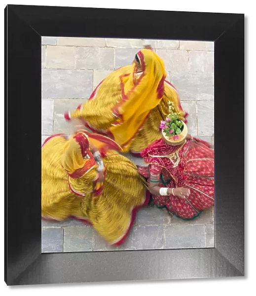 India, Rajasthan, Jaipur, Samode Palace, women wearing colourful Saris dancing (MR, PR)