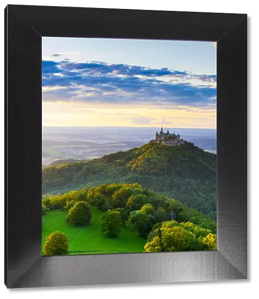 Elevated view towards Hohenzollern Castle and sourrounding countryside illuminated at sunset
