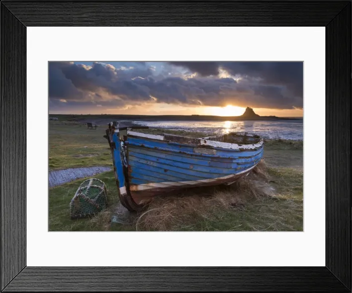 Framed Print : Decaying fishing boat on Holy Island at dawn, with Lindisfarne Castle beyond, Northumberland
