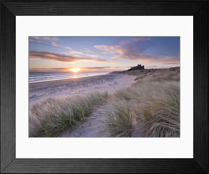 Framed Print : Sunrise over Bamburgh Beach and Castle from the sand dunes, Northumberland, England Framed Print : Sunrise over Bamburgh Beach and Castle from the sand dunes, Northumberland, England