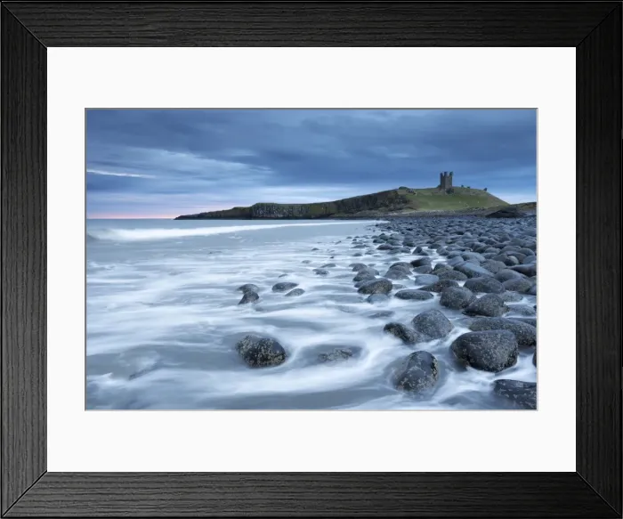 Framed Print : The ruins of Dunstanburgh Castle overlooking the boulder strewn shores of Embleton Bay Framed Print : The ruins of Dunstanburgh Castle overlooking the boulder strewn shores of Embleton Bay