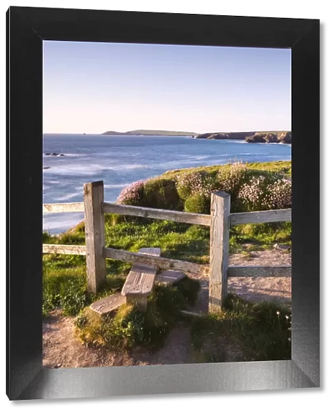Wooden stile on Cornish clifftops near Porthcothan Bay with views to Trevose Head