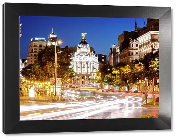 Spain, Madrid. Street view with Metropolis building and light trails