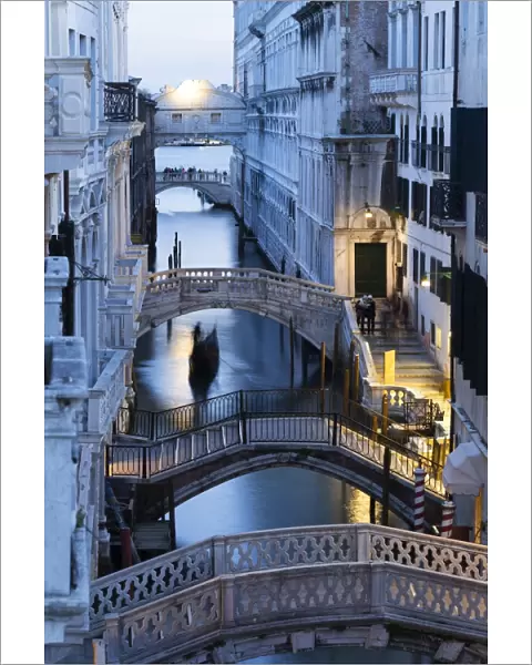 Venice, Veneto, Italy. Bridges over a canal with Bridge of Sights in the background