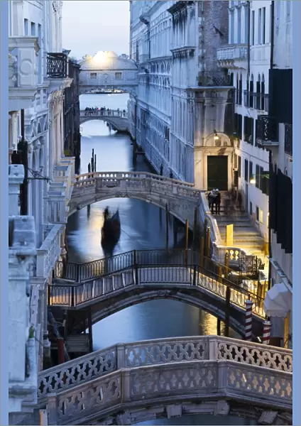 Venice, Veneto, Italy. Bridges over a canal with Bridge of Sights in the background