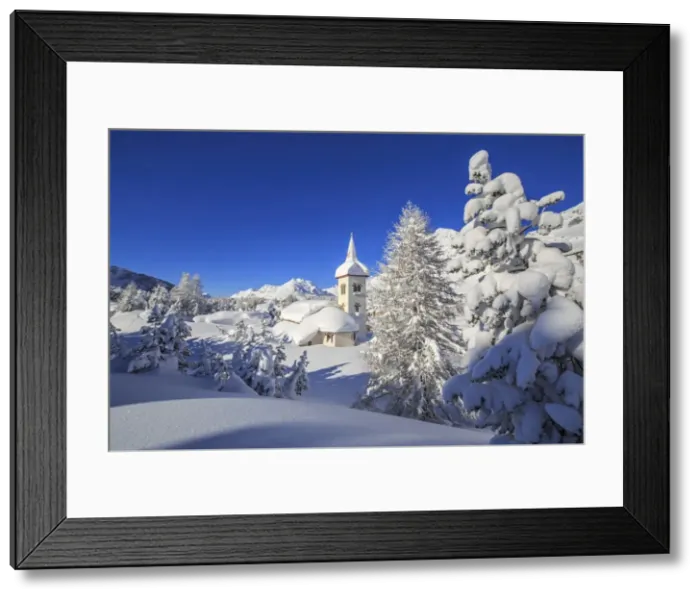 Framed Print : The winter sun illuminate the snowy landscape and the typical church Maloja Canton Framed Print : The winter sun illuminate the snowy landscape and the typical church Maloja Canton