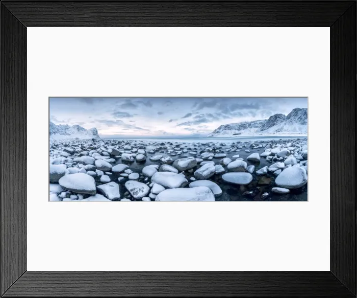 Framed Print : Rocks in the cold sea and snow capped mountains under the blue light of dusk Unstad Framed Print : Rocks in the cold sea and snow capped mountains under the blue light of dusk Unstad
