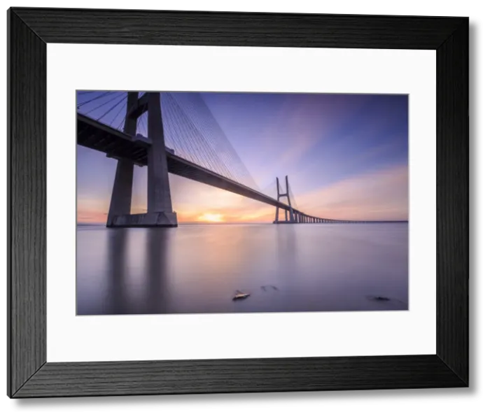 Framed Print : The sun rises on the Vasco da Gama Bridge that spans the Tagus River in Parque das NaA'A§A'Aµes Lisbon Portugal Europe Framed Print : The sun rises on the Vasco da Gama Bridge that spans the Tagus River in Parque das NaA'A§A'Aµes Lisbon Portugal Europe