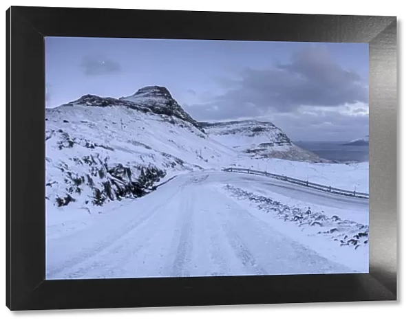 Snow covered mountain road on the Island of Streymoy, Faroe Islands, Denmark, Europe