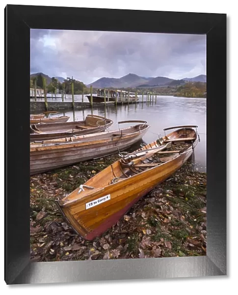 Wooden rowing boats beside Derwent Water in the Lake District, Cumbria, England. Autumn