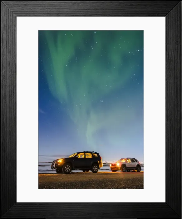 Framed Print : Iceland, Europe. Cars with lights on at night under a starry sky and the northern lights Framed Print : Iceland, Europe. Cars with lights on at night under a starry sky and the northern lights