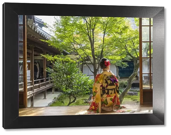 Woman looking out onto Zen garden, Kyoto, Japan