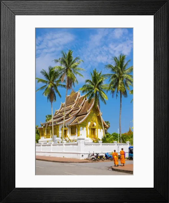 Framed Print : Monks passing Haw Pha Bang temple on the grounds of the Royal Palace, Luang Prabang
