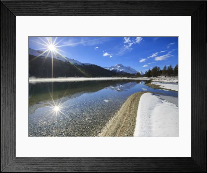 Framed Print : Rays of winter sun illuminate Lake Silvaplana still partially frozen Maloja Engadine Framed Print : Rays of winter sun illuminate Lake Silvaplana still partially frozen Maloja Engadine