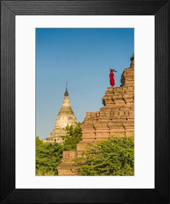Framed Print : Bagan, Mandalay region, Myanmar (Burma). A young monk watching the Shwesandaw pagoda Framed Print : Bagan, Mandalay region, Myanmar (Burma). A young monk watching the Shwesandaw pagoda