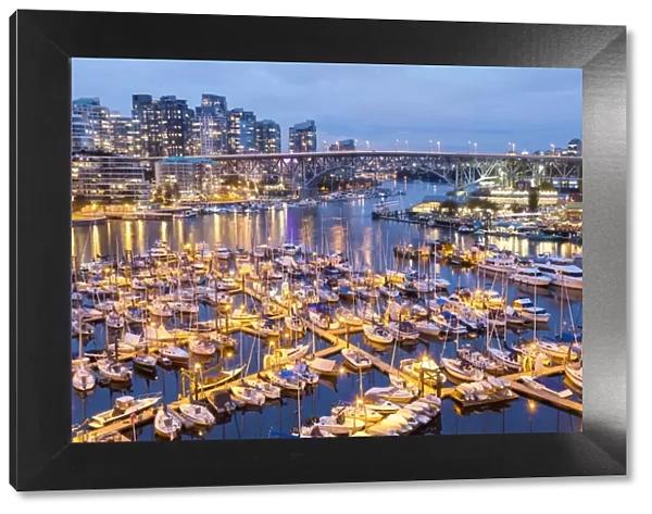 View over harbour & Granville Island with city skyline at dusk, Vancouver, British Columbia