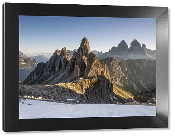 The Cadini di Misurina peaks are shot as the sun is rising in the Dolomites, with
