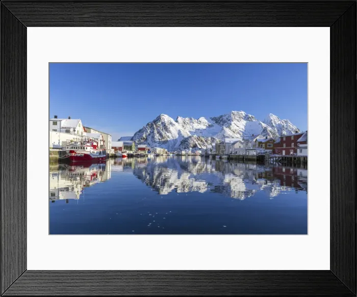 Framed Print : Houses and mountains reflected in the waters of Henningsvaer fjord. Lofoten Islands