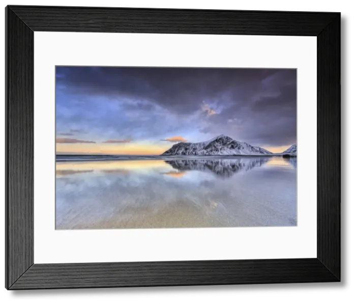 Framed Print : Sunset on Skagsanden beach surrounded by snow covered mountains reflected in the cold sea