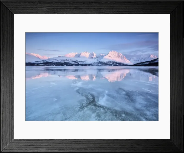 Framed Print : The last lights of dusk coloring the snowy Lyngen alps reflecting in the half frozen Framed Print : The last lights of dusk coloring the snowy Lyngen alps reflecting in the half frozen