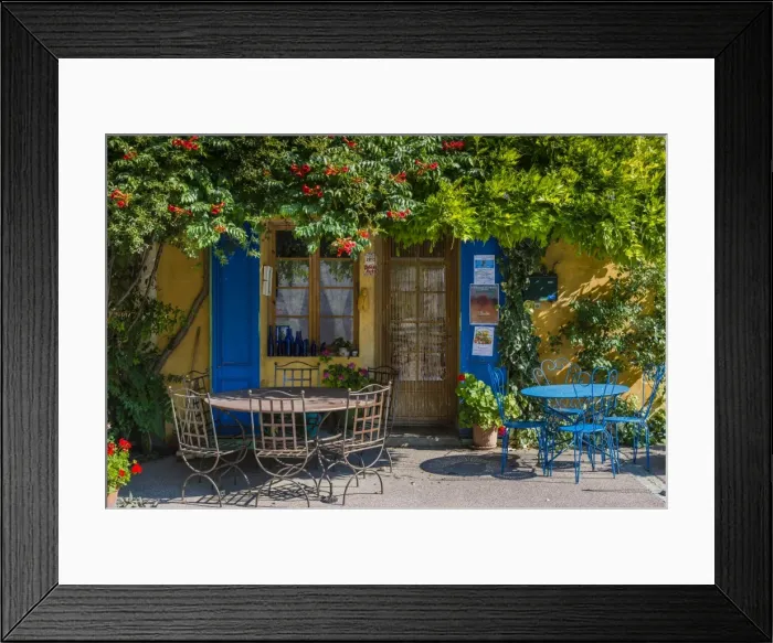 Framed Print : Ivy surrounded house front door with table and chairs in Provence, France Framed Print : Ivy surrounded house front door with table and chairs in Provence, France