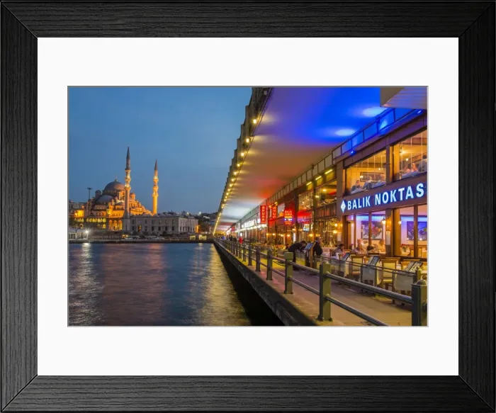 Framed Print : Outdoor restaurants under Galata Bridge with Yeni Cami or New Mosque in the background at dusk Framed Print : Outdoor restaurants under Galata Bridge with Yeni Cami or New Mosque in the background at dusk