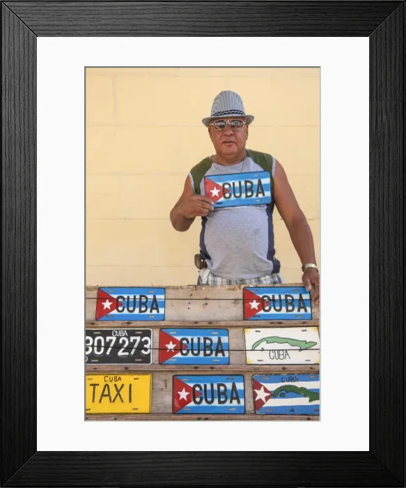 Framed Print : Cuba, Trinidad, Man selling Cuban car number plates